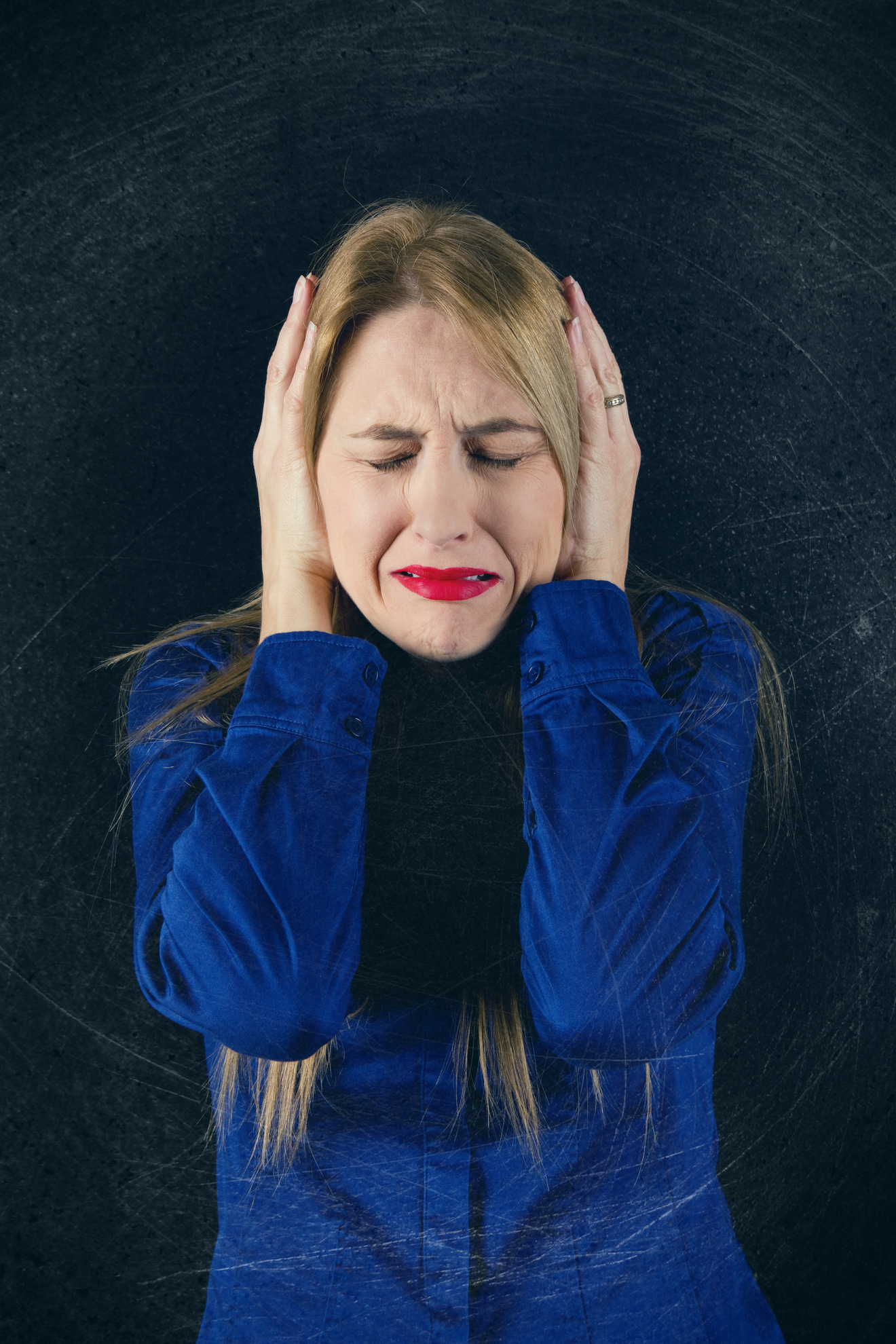 Overstimulated Woman Covering Ears